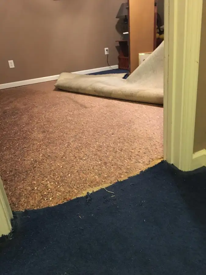 Carpet pad removal revealing water damage during Water Mitigation Services in Mint Hill